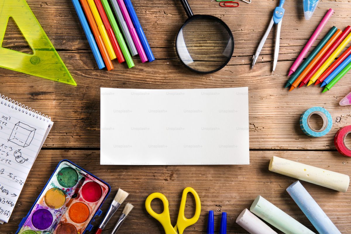 School supplies on a wooden desk — back-to-school shopping